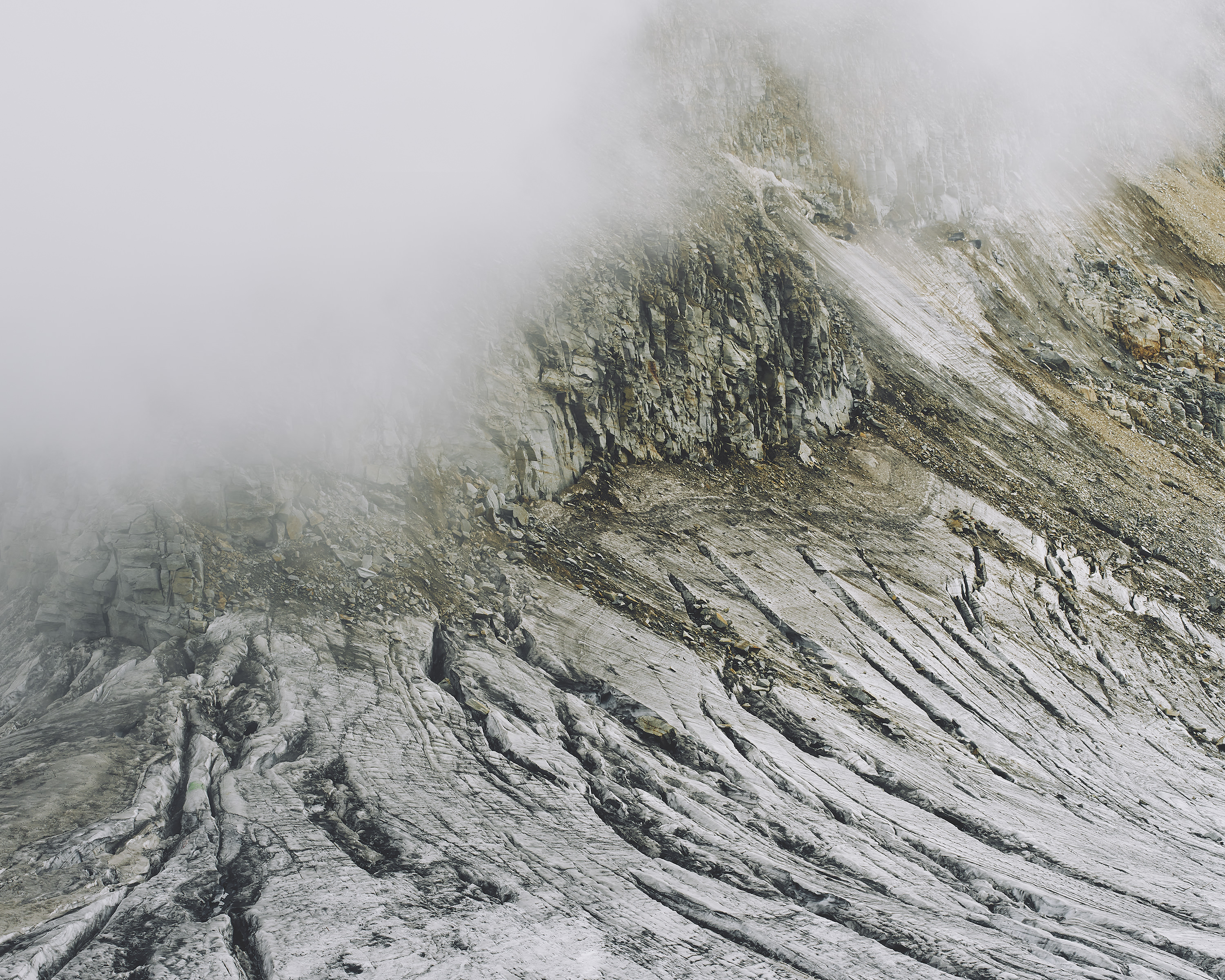 A breathtaking detailed view of a snow-capped mountain surrounded by a mysterious fog